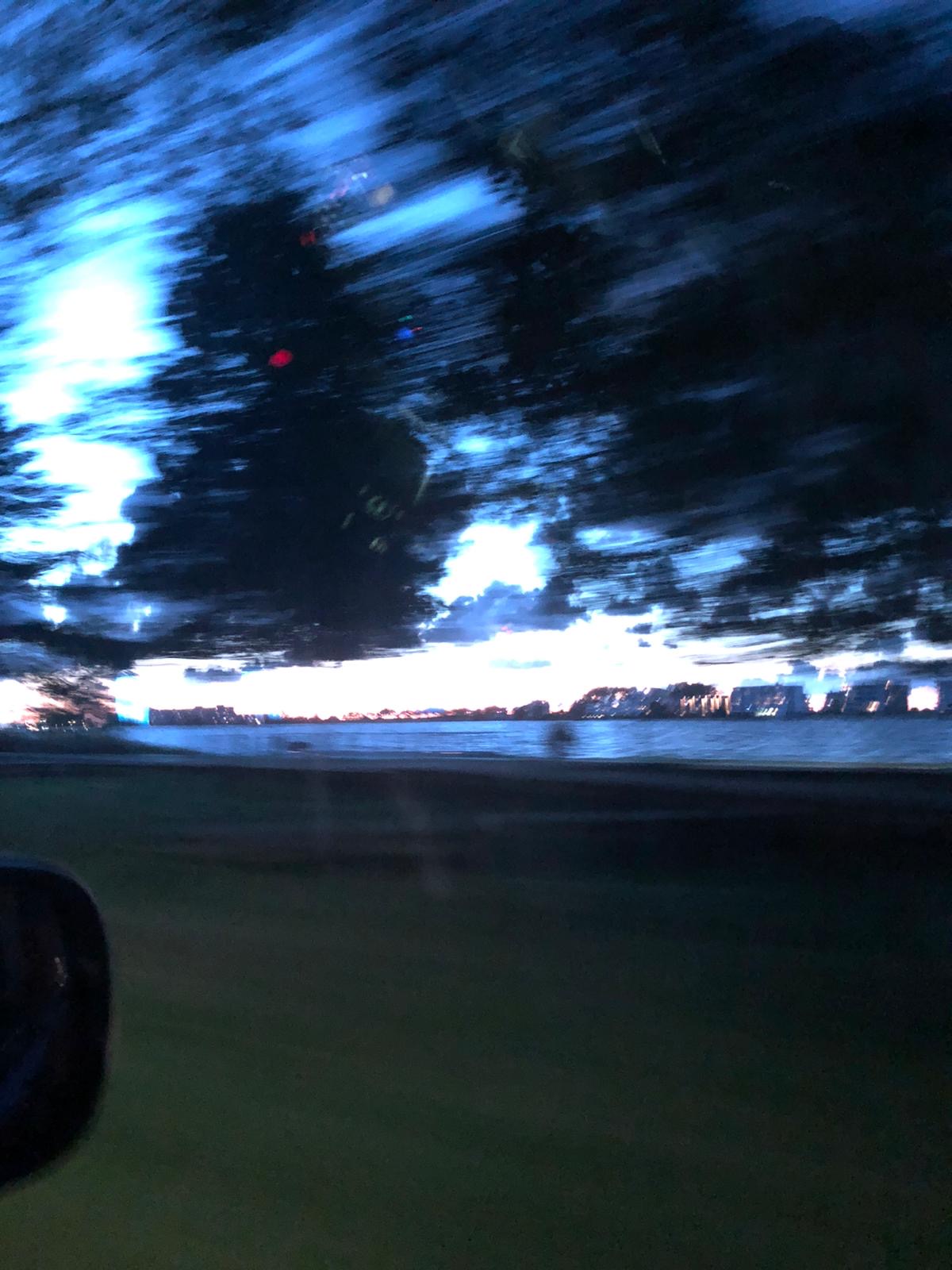 Photo of a lake taken from a moving car