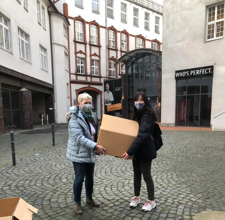 Moving boxes are carried into the new office.